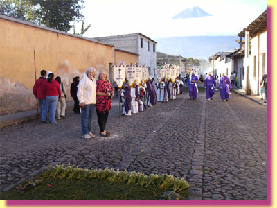 Barbara and Catherine in front of a line of boys, who carry a story of the trial of Jesus ... click to see a large image