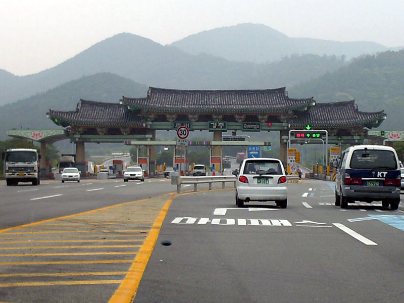 Gyeongju is a special, historic town.  Even gas stations are built as pagods and here we are leaving the town for the highway, through the pagoda toll booth ... click to see a large image. 