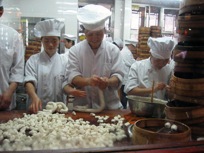 Making dumplings in the Yu Gardens complex ... click to see a large image.
