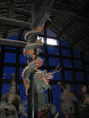 Serpents climb the posts of the temple of ghost
